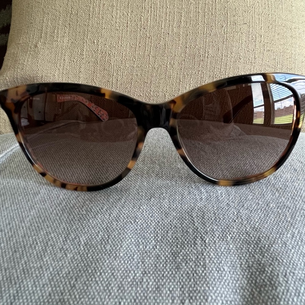 Kate Spade tortoise sunglasses with floral design.